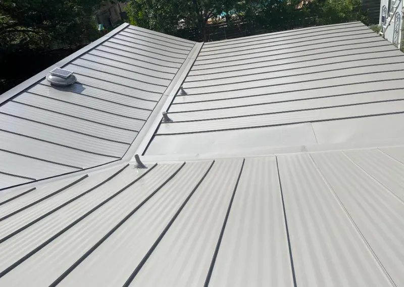 Solar attic fan installed on a metal roof for Roof Ventilation in Cleveland Heights